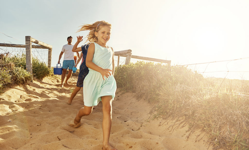 Shot of a young family arriving at the beach